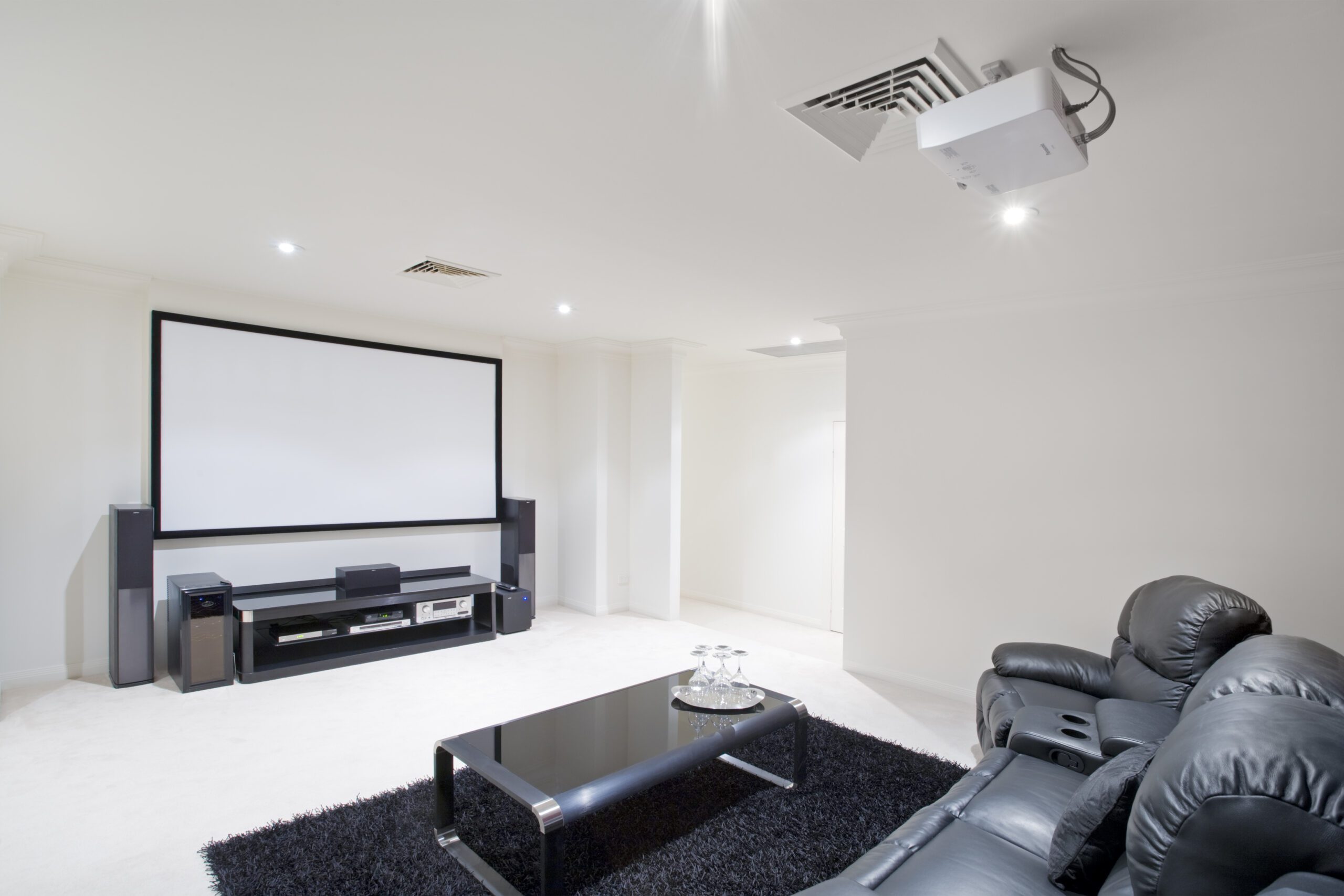 Home theater room with black leather recliner chairs