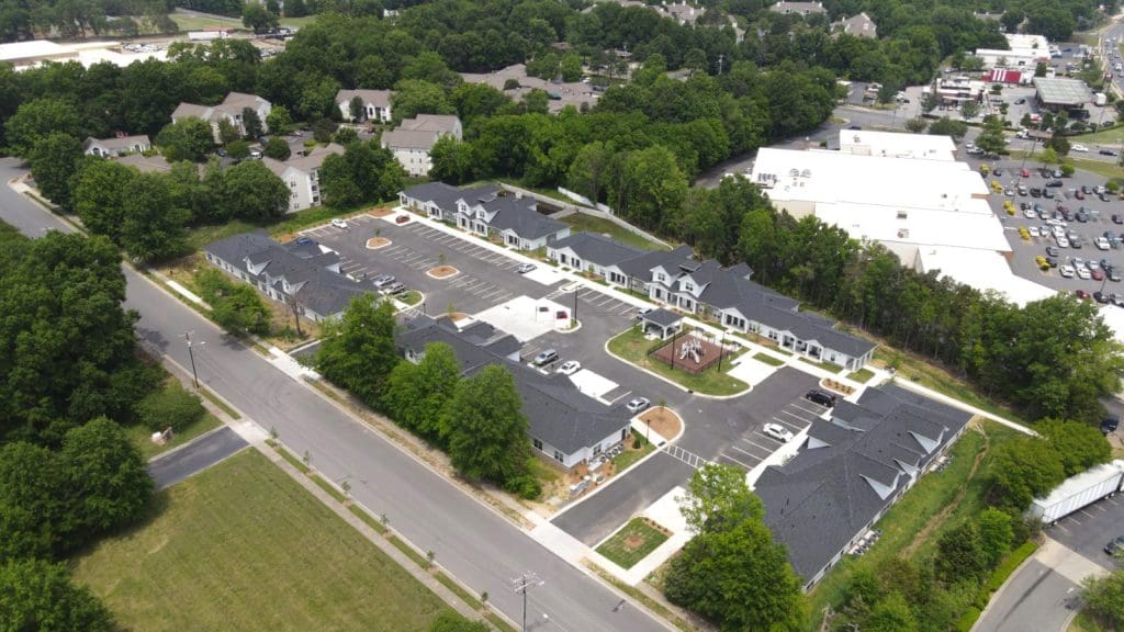 Aerial view of Abbington Westside in Charlotte, apartment buildings beside a main road.
