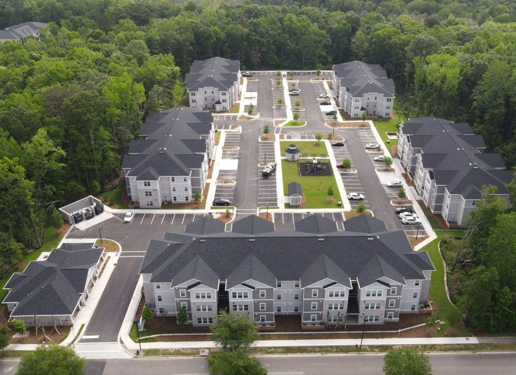 Aerial view of Bluehouse Commons near Charleston, South Carolina, three-storey apartment buildings along a central drive.