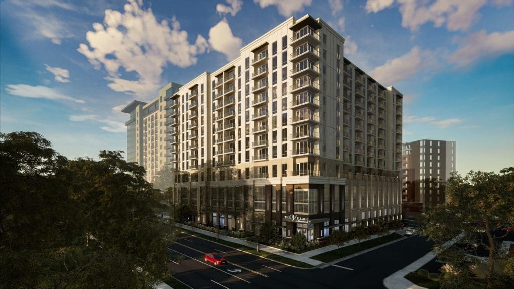 The Village on Morehead in Charlotte, a twelve-storey senior living tower photographed at dusk.